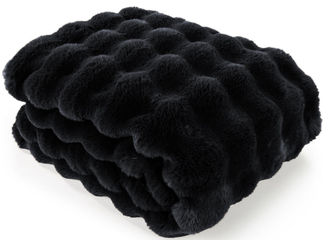 A folded black faux fur blanket with a wavy, tufted texture, shown on a clean white background.