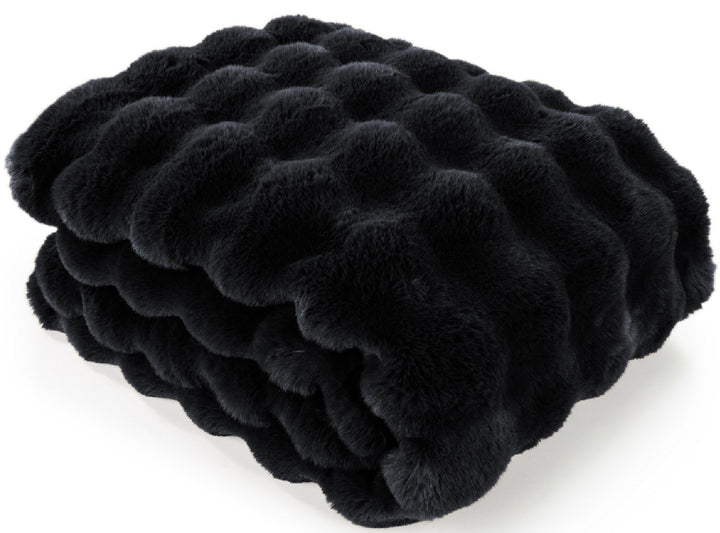 A folded black faux fur blanket with a wavy, tufted texture, shown on a clean white background.