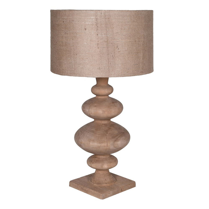 Table lamp with wooden base and beige fabric shade on a white background