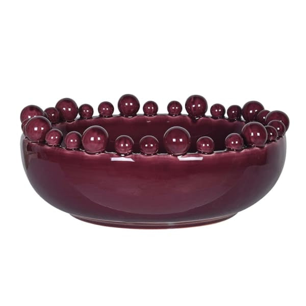 A glossy deep burgundy ceramic bowl with a decorative border of raised spherical beads around the rim, shown against a plain white background.