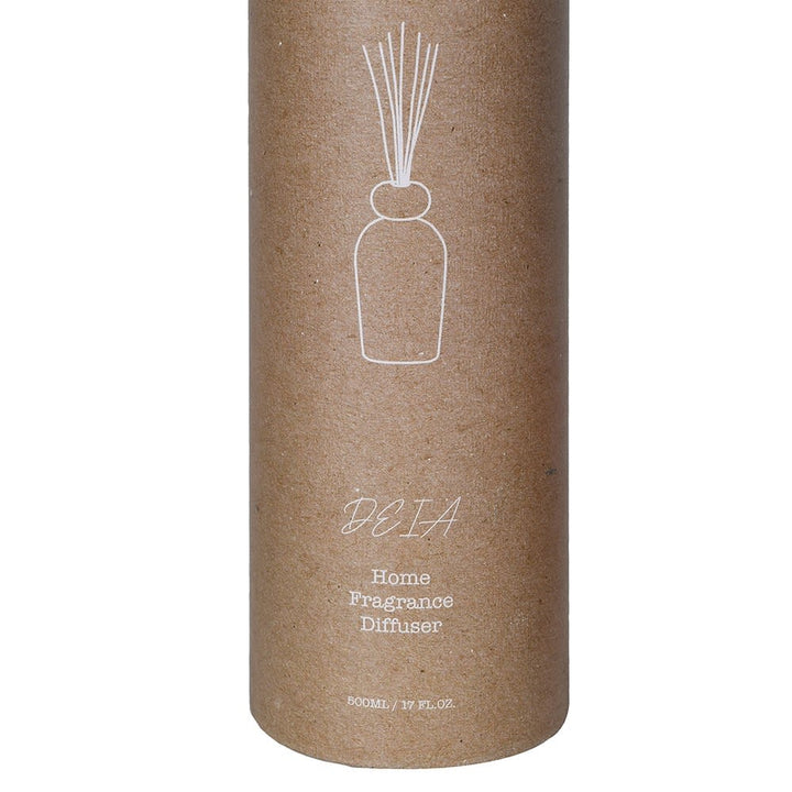 A brown kraft paper cylindrical package for a reed diffuser, featuring a white line drawing of a diffuser bottle with reeds and the text &