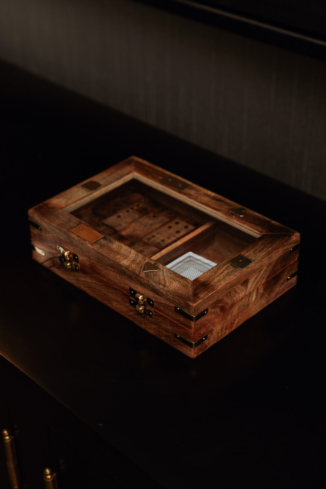 Wooden jewelry box with intricate details on a dark background