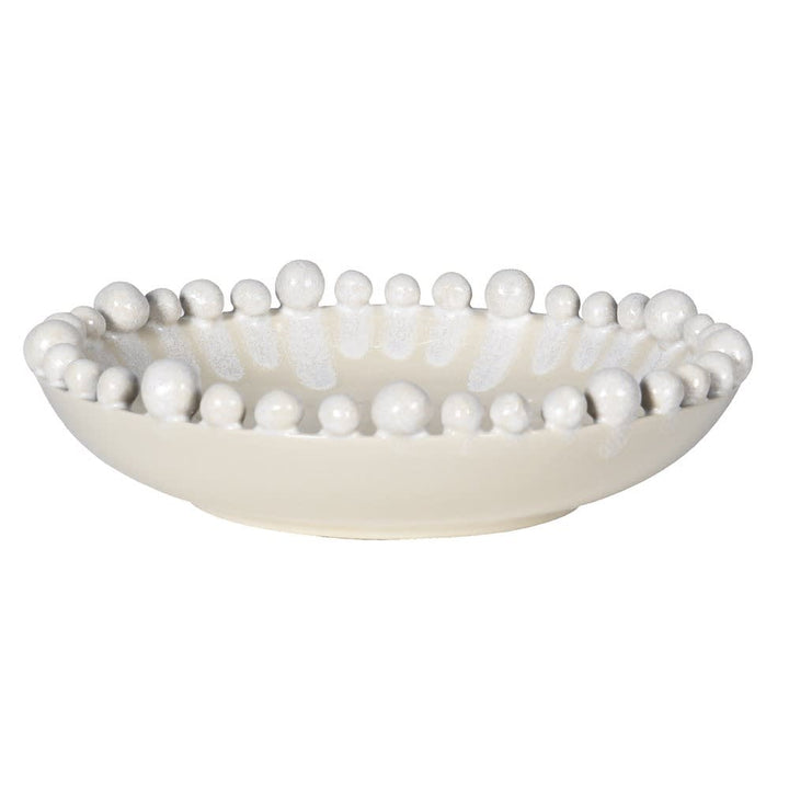 Decorative bowl with bead-like embellishments on a white background