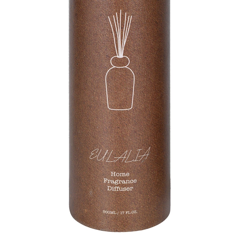 A cylindrical brown diffuser container with a white line drawing of a reed diffuser and the text &
