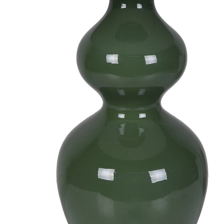 Green ceramic vase on a white background
