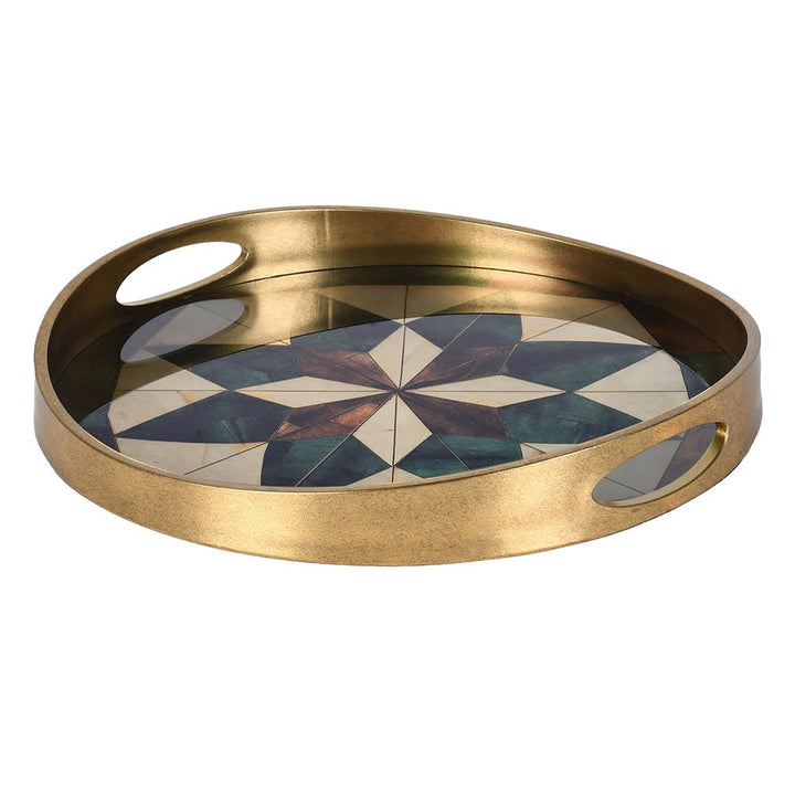 Round brass serving tray with two oval cutout handles and a geometric mosaic inlay on the base featuring shades of blue, green, white, and bronze.