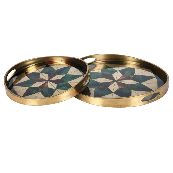 Two round brass serving trays with star-patterned inlay, displayed on a clean white background.