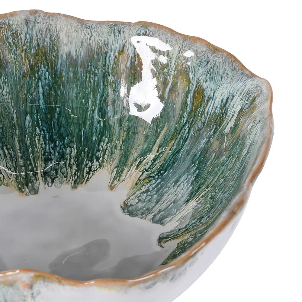 Ceramic bowl with textured green and gray exterior on a white background