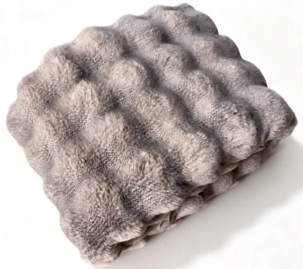 A folded gray faux fur blanket with a textured, wavy tufted pattern, shown on a plain white background.