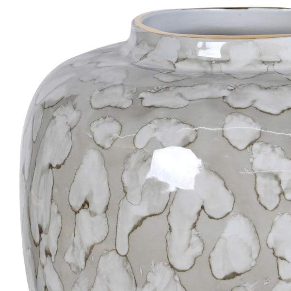 Close-up of a glossy ceramic vase with a gray and white abstract organic pattern, showing a reflective highlight on the surface.