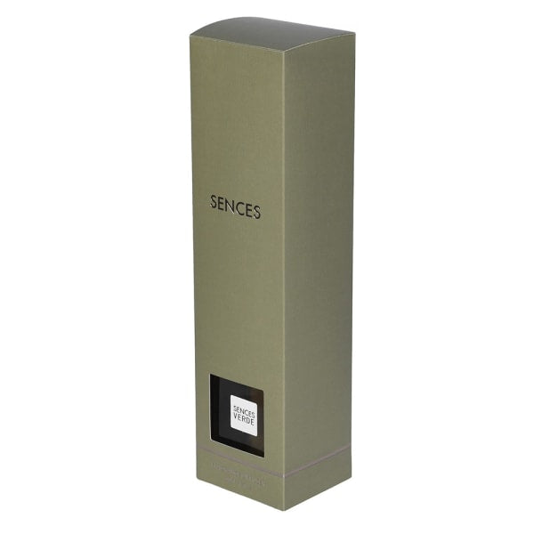 A tall, minimalist rectangular box for Senses by Serge Lutens, featuring a matte olive green exterior, black text, and a small black window displaying the Scent of Ylang Ylang label.