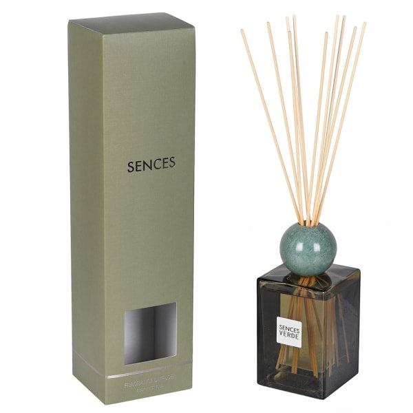 Sences reed diffuser set with a tall olive green box, a dark glass bottle, a teal-green marble sphere, and natural reed sticks on a white background.