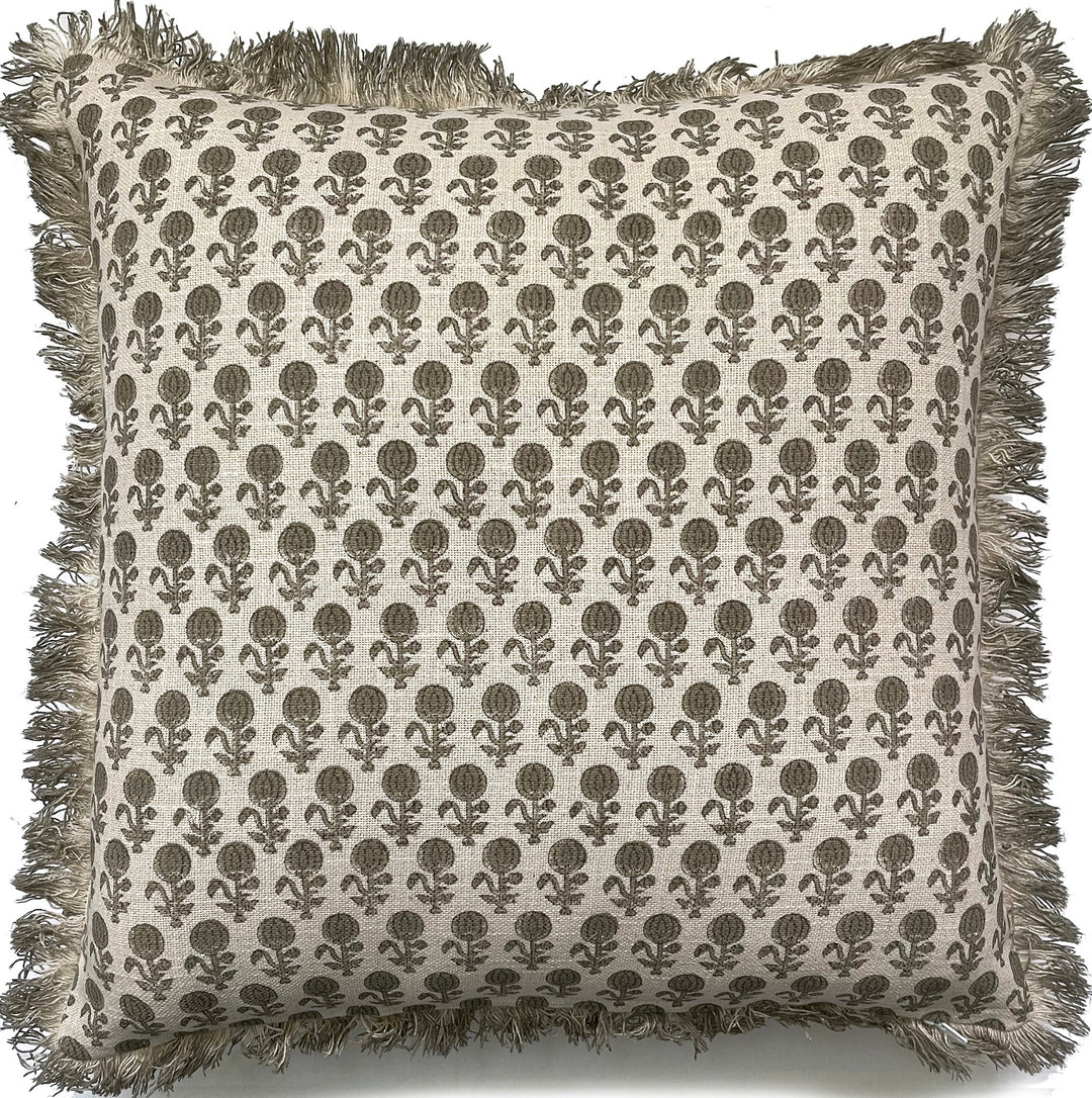 A square throw pillow with a beige and brown block-printed floral pattern and fringed edges, shown against a plain white background.