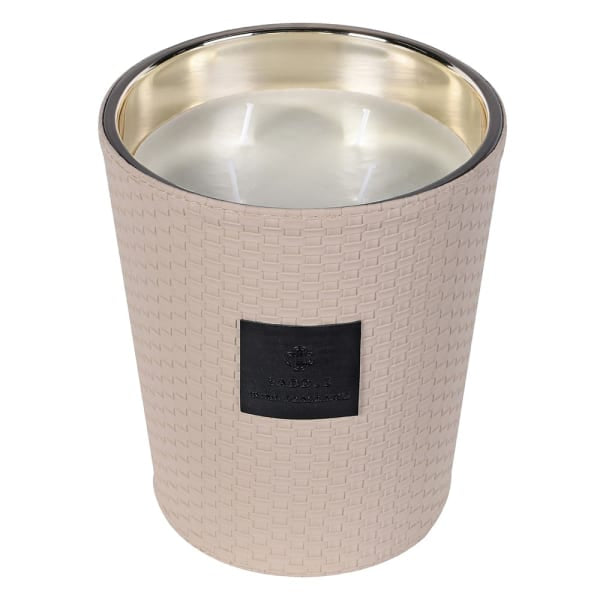 Beige textured candle with a gold interior on a white background