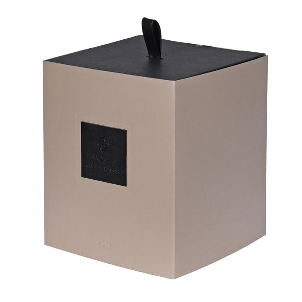 Beige box with a black lid on a white background
