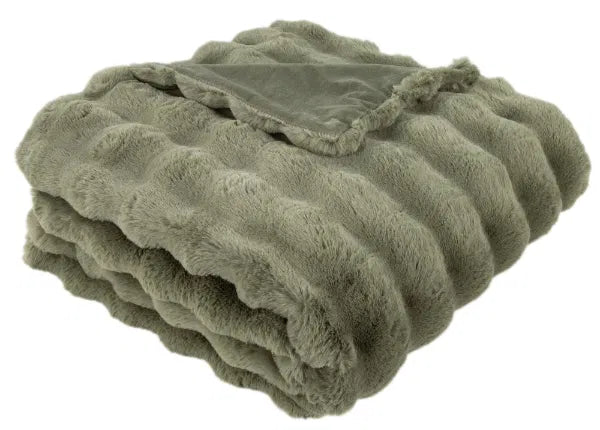 Folded green blanket on a white background