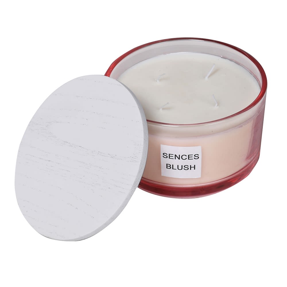 Candle in a red container with a white lid on a white background
