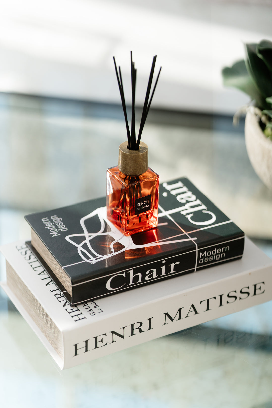 Diffuser bottle on a stack of books with a blurred background