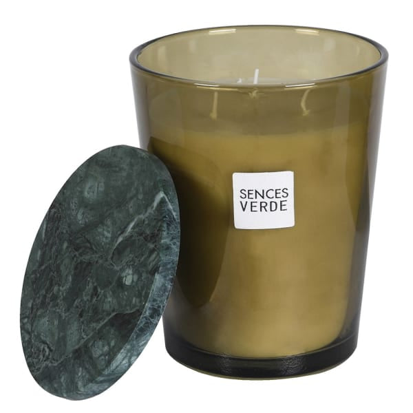 An amber glass candle jar with a white label reading &