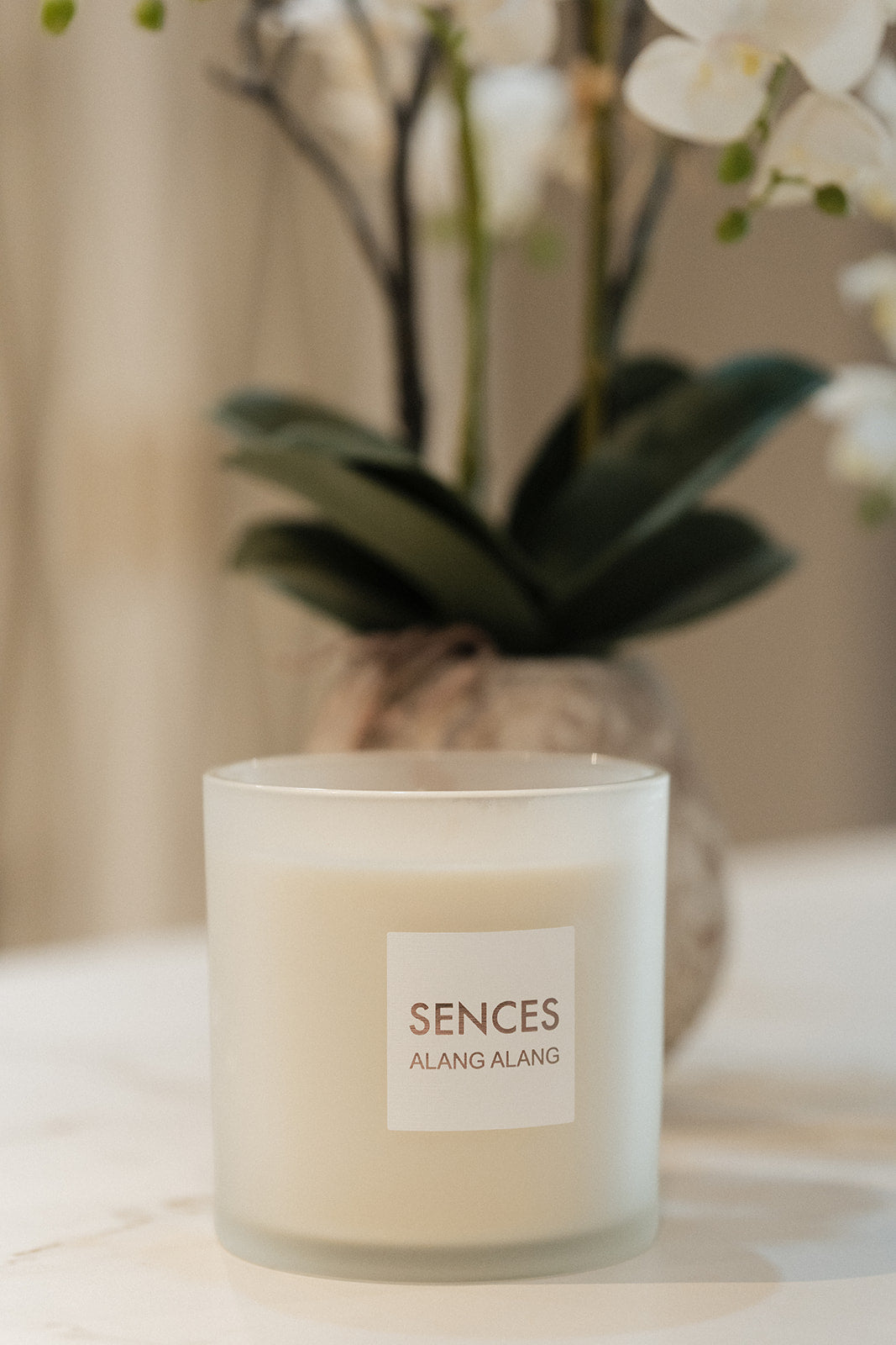 A frosted glass candle jar labeled &