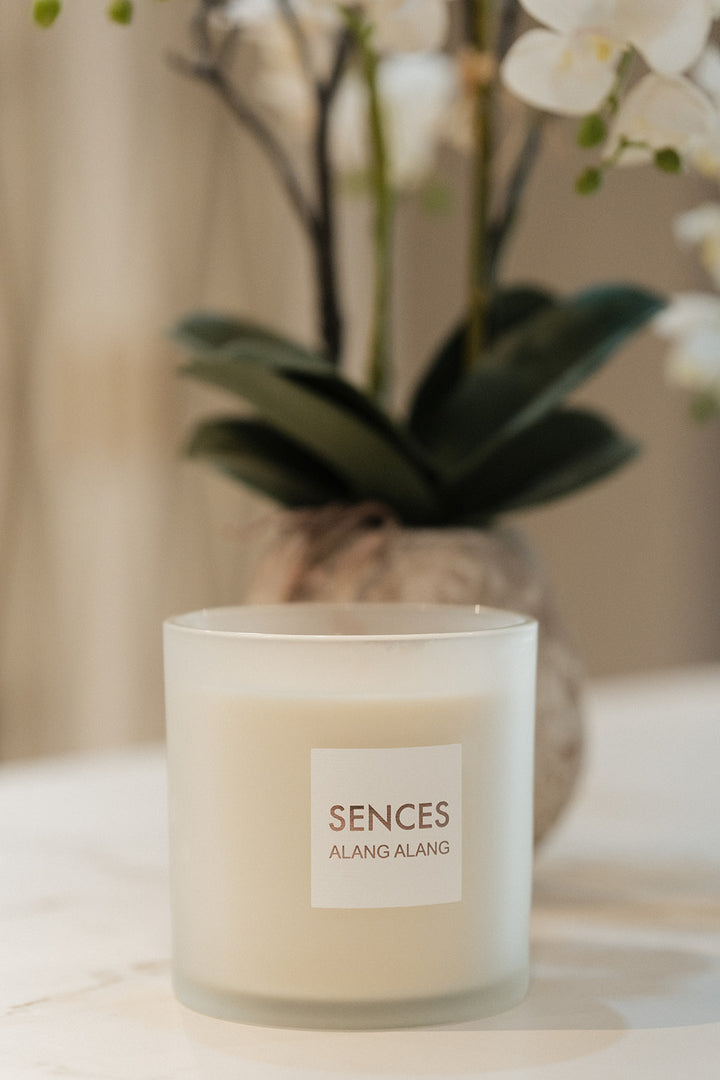 A frosted glass candle jar labeled &