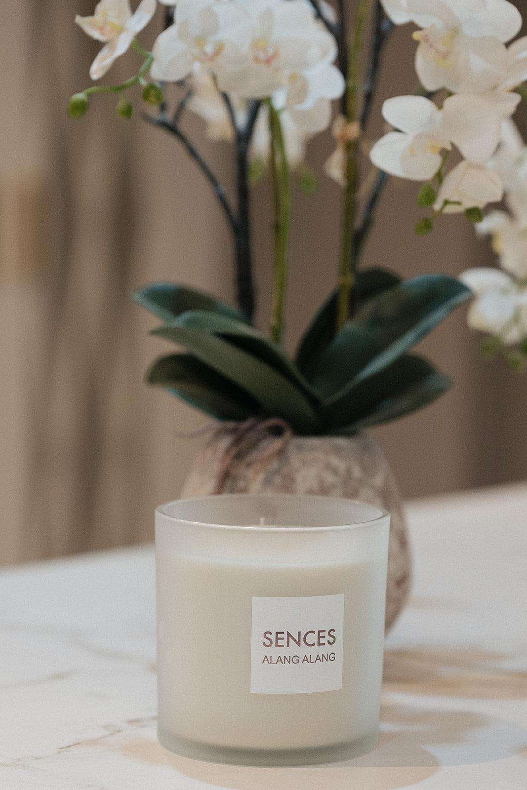 A frosted glass jar candle labeled &