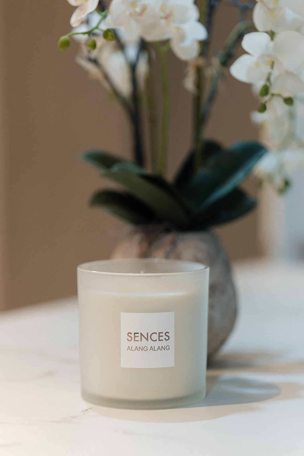 A frosted glass candle jar labeled &