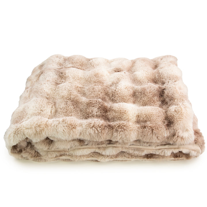 Beige faux fur blanket on a white background