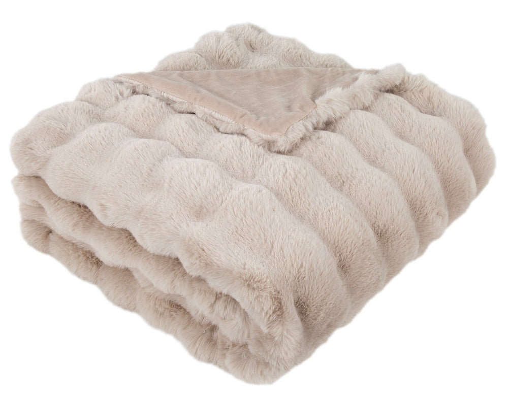 Folded beige blanket on a white background