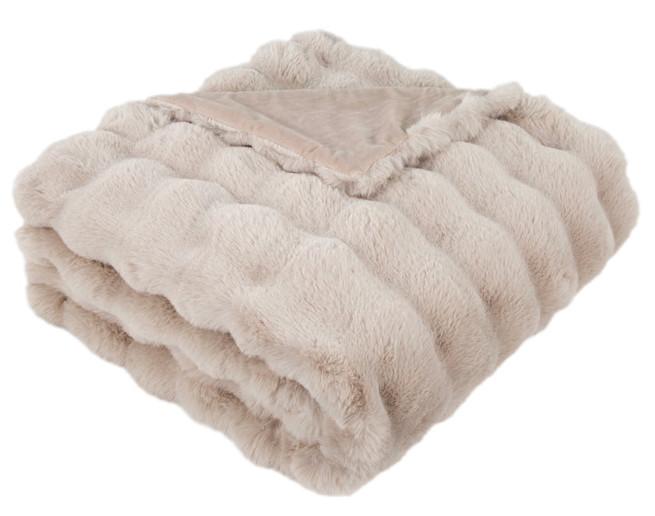 Folded beige blanket on a white background