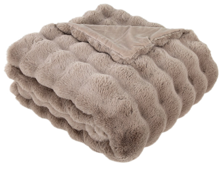 Folded beige blanket on a white background