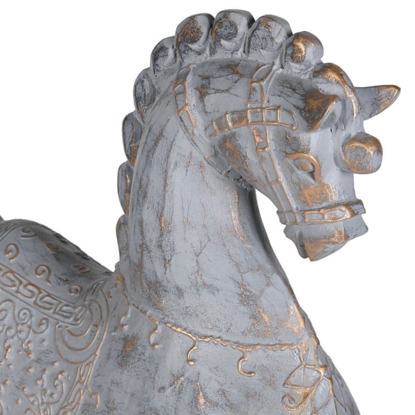 A close-up of a decorative horse figurine with a distressed gray finish and gold-painted accents, shown against a plain white background.