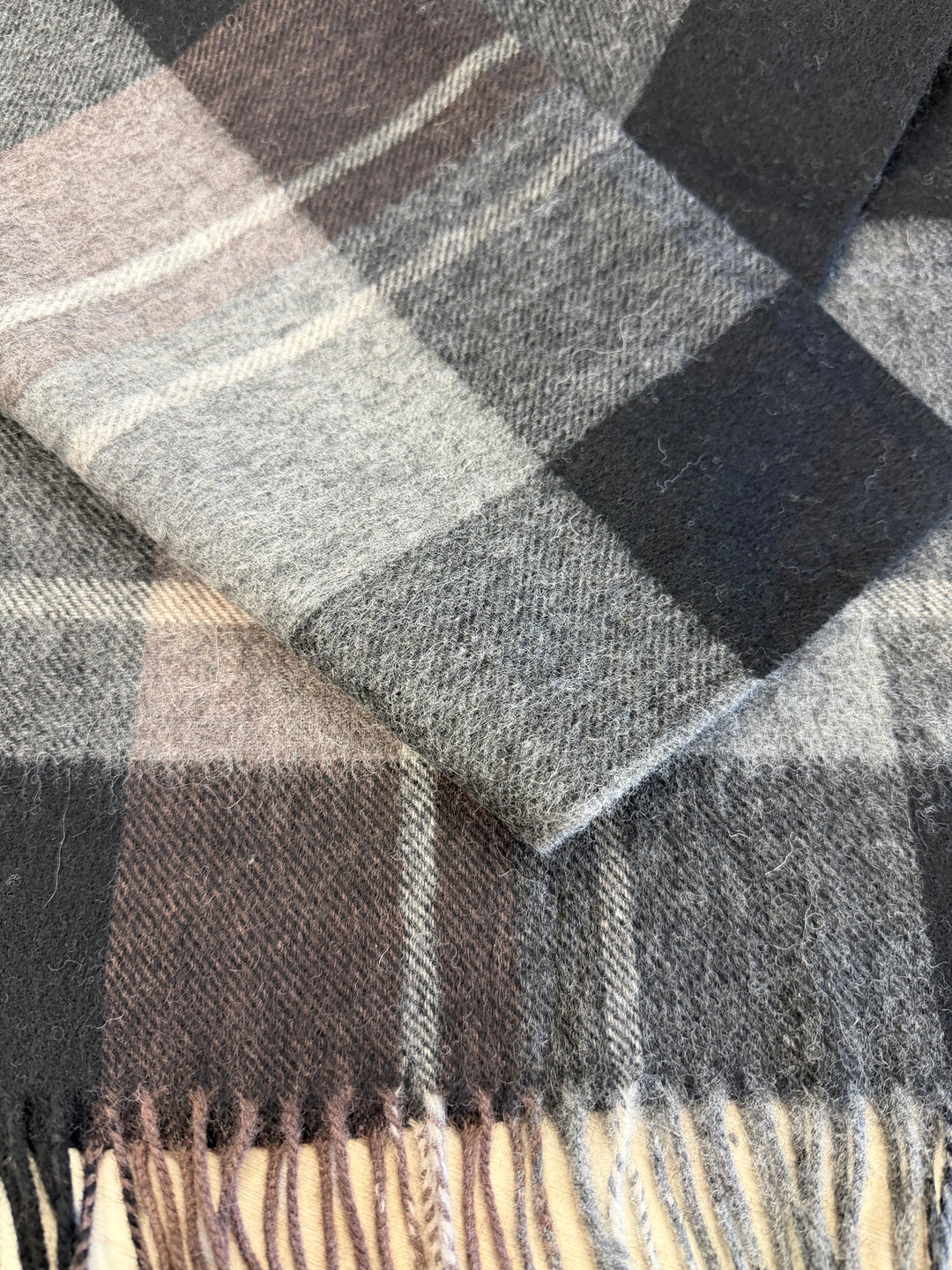 Close-up of a checkered fabric with brown, gray, and black colors.