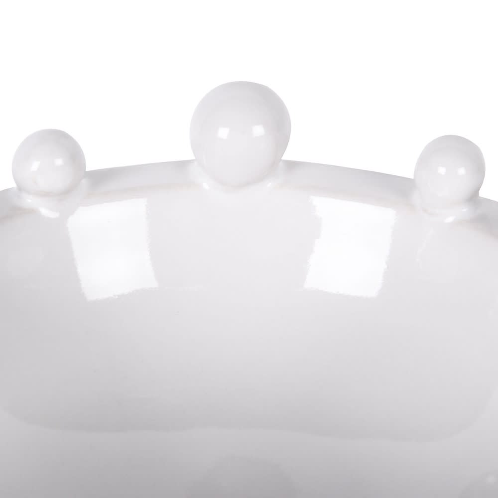 Close-up of a white crown with three spherical ornaments on a white background